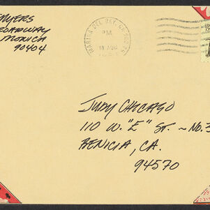 Handwritten envelope addressed in black ink to Judy Chicago with colorful decorations in three corners