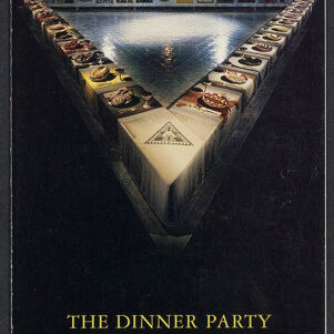Full-color, printed cover of an invitation to The Dinner Party Exhibition with a photograph of a triangular table, open in the center and lined with place settings