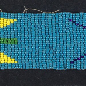 Turquoise horizontal strip of beading with two abstract, star-like motifs in different colors