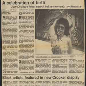 Newspaper article with a photographic portrait of Judy Chicago standing in front of an artwork