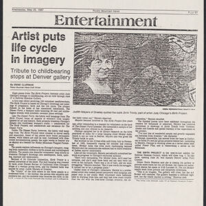 Photocopy of a newspaper article with a photograph of a woman standing in front of a fabric artwork