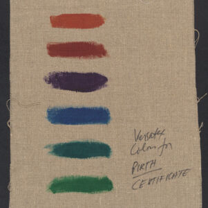Eight different colored paint samples on a piece of brown fabric with handwritten annotation in black ink