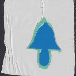 Blue and green applique of a tree-like shape on white fabric