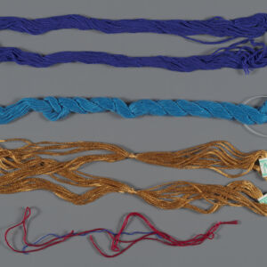 Four skeins of embroidery thread in blue, turquoise, gold and red