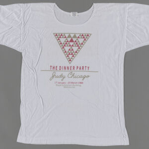 White t-shirt with a downward-pointing triangle filled with smaller triangels in gray and pink with gray and pink type