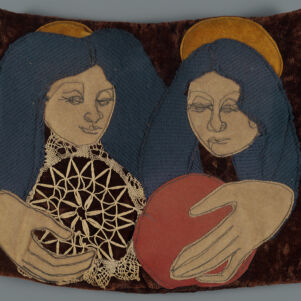 Fabric artwork of two women with dark blue hair and gold halos holding lace and red circles on a brown background