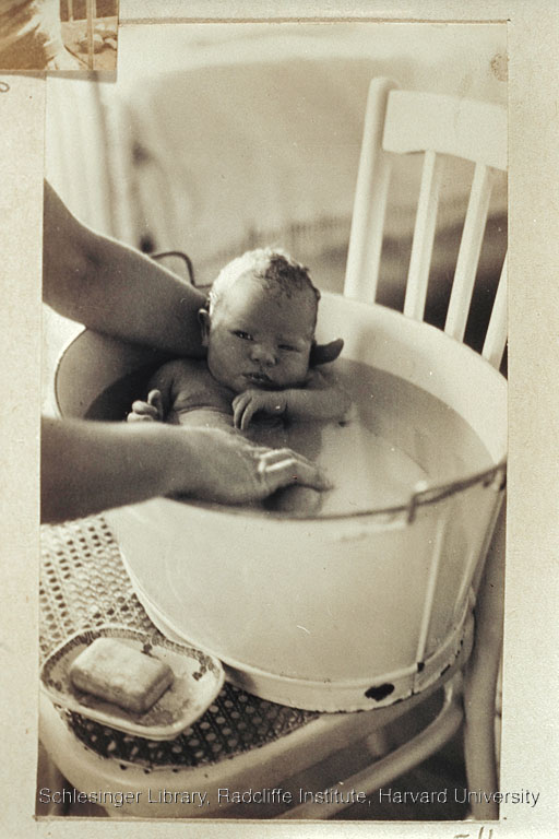  An unidentified woman bathing an infant Sylvia Cabot in a tub.