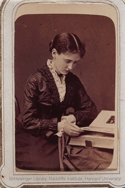 Portrait of Susan Munroe Stowe, looking at a photograph album.