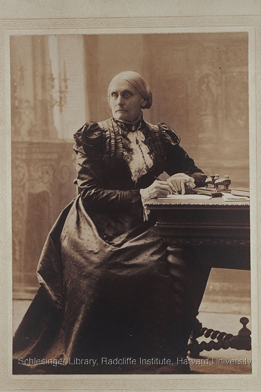Formal portrait of Susan B. Anthony sitting at a desk. 