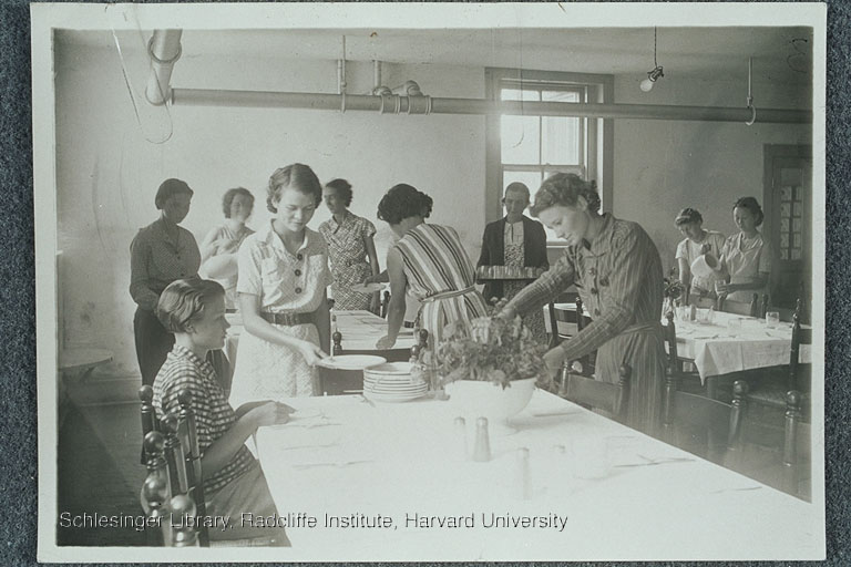 Women participating in a home economics class at a school or camp for unemployed work in Brevard, N.C. They are setting tables and arranging flowers. 