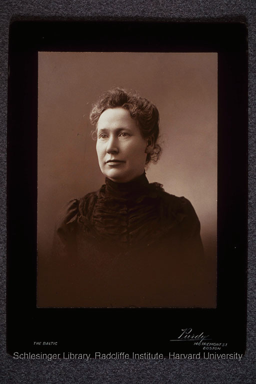 Formal portrait of a young Mary Kenney O'Sullivan wearing a black dress.