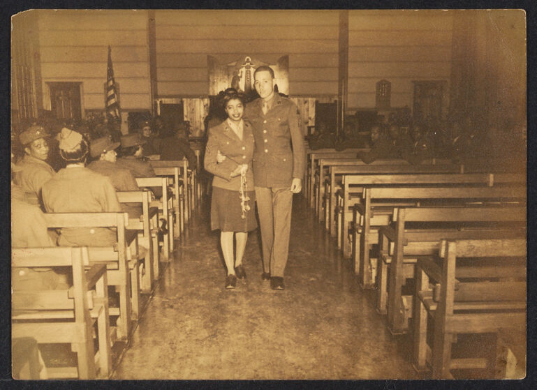 Wedding ceremony of African American couple in military dress