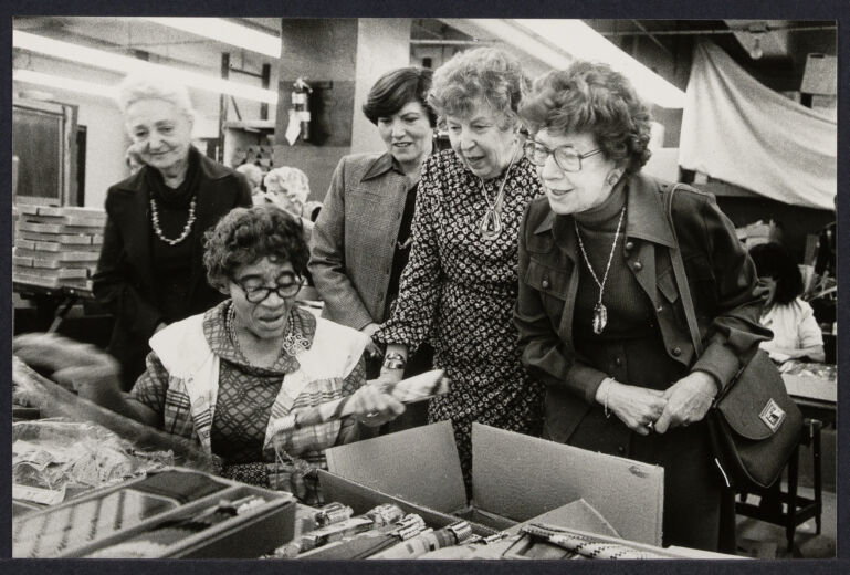 National Council of Jewish Women Older Women Workshop, photographed by Bettye Lane April 13 1978. A group of five women looking at objects on a table, one seated the rest standing.