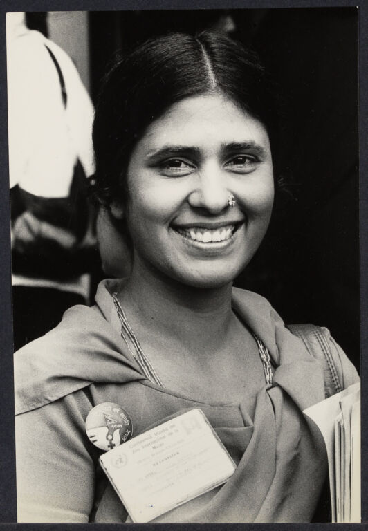 Delegate to the United Nations from India wearing a name badge, smiling at camera. 