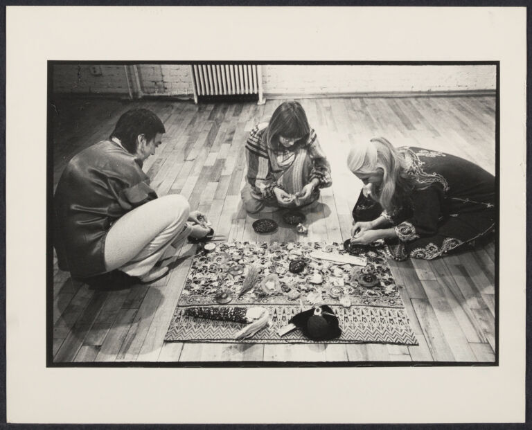 Three women sitting around an altar as part of an Earth Goddess Workshop.