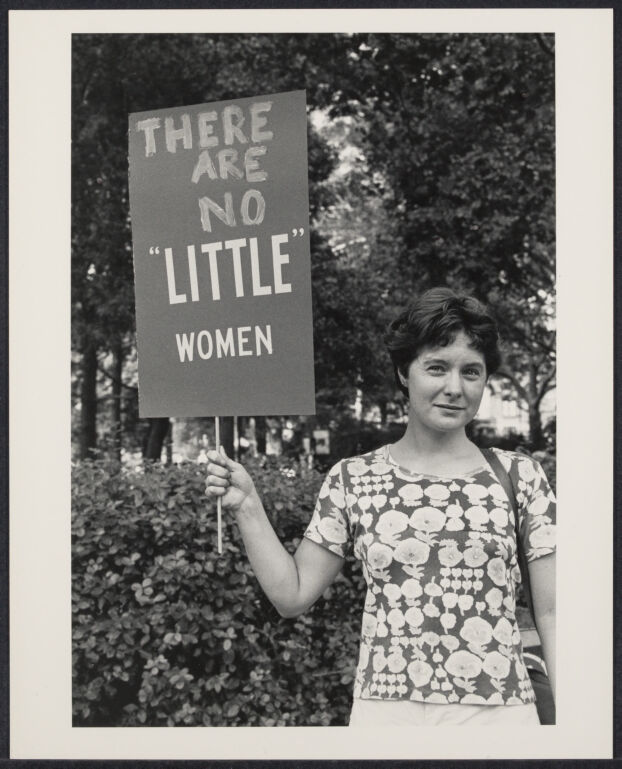 Women's rights demonstration, sign reads, "There are no little women"