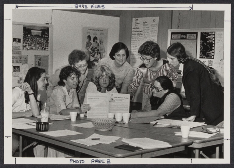 Automation committee of 9 to 5 looking at a pamphlet, 1983